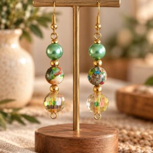 Pendientes Brillo de Jaspe en soporte de madera con fondo natural.